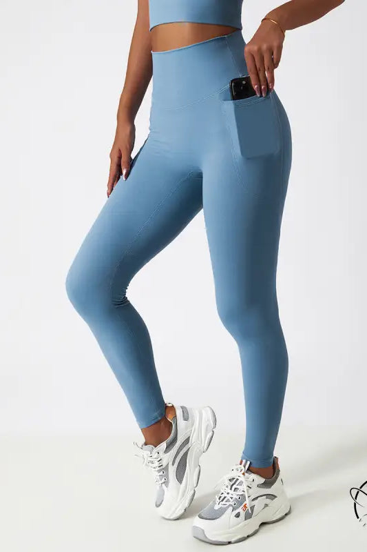 Light blue high-waisted yoga pants with side pocket and hip lift design