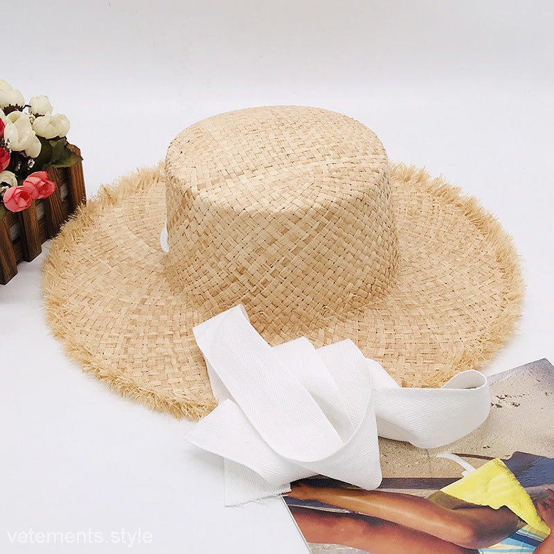 Cute wide-brim sun hat in neutral beige with bow detail