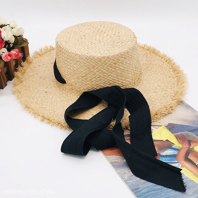 Cute sun hat: wide-brim straw with black ribbon, frayed edge, neutral beige