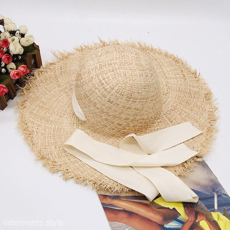 Cute wide-brim sun hat with cream ribbon bow and pure white hatband
