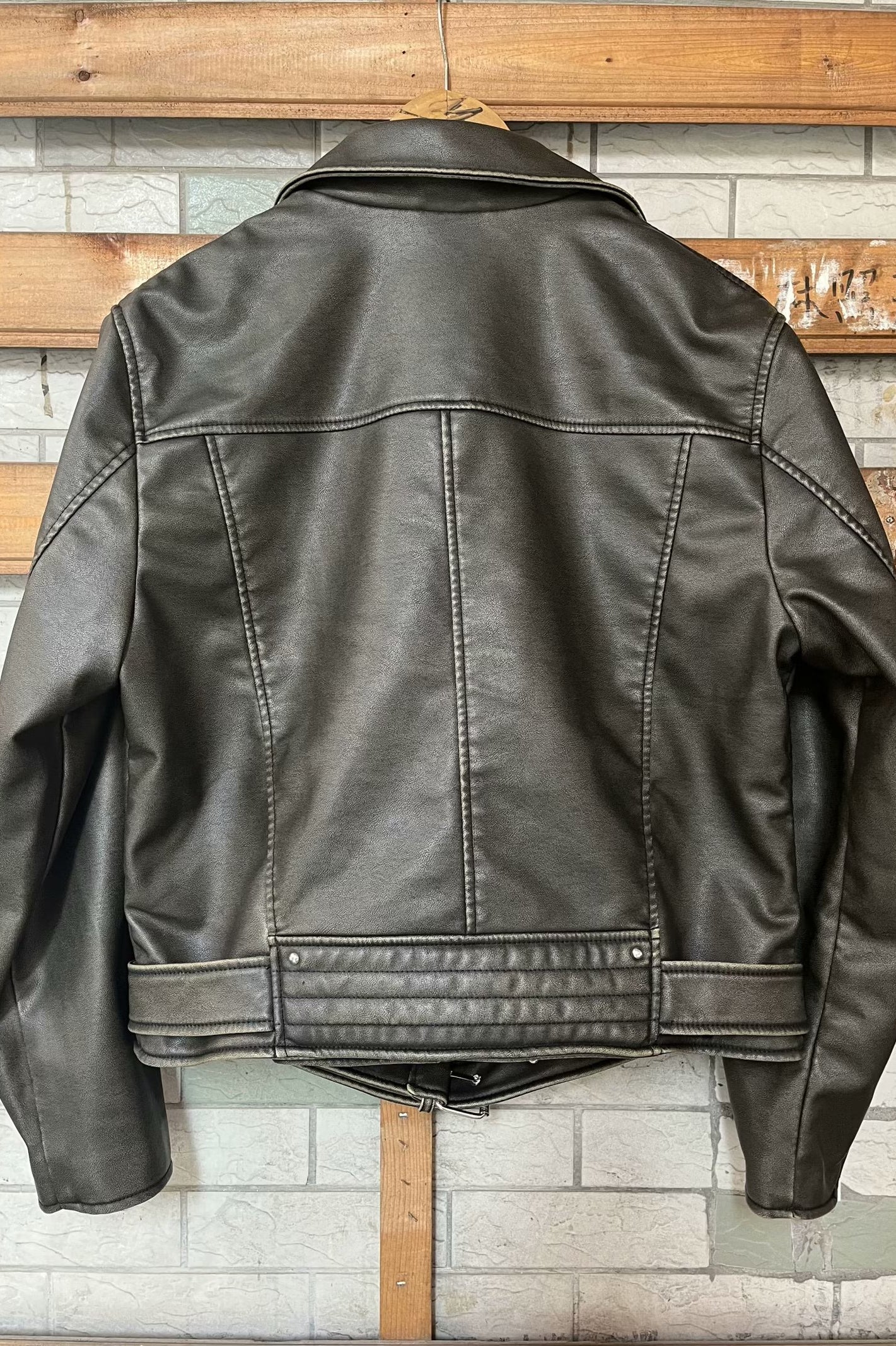 Beautiful warm brown leather jacket with black stitching and zipper details