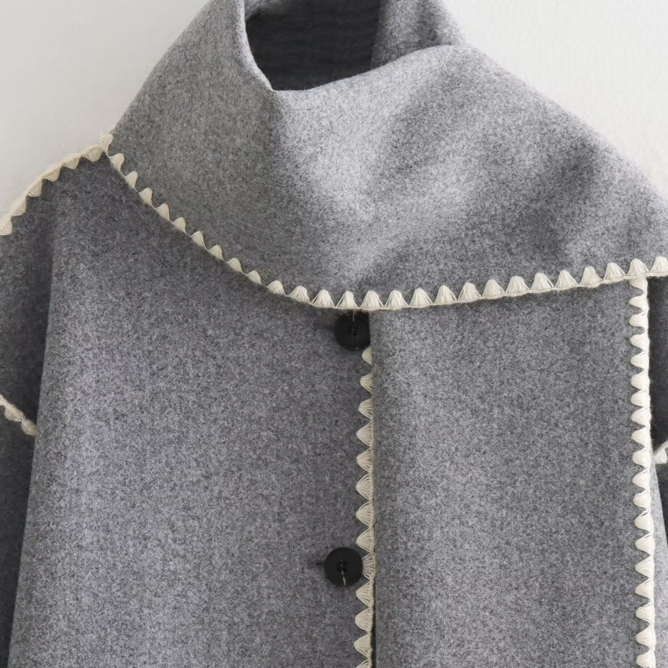 Gray wool cape with white trim showcasing the Vintage Stitching Coat in elegant design