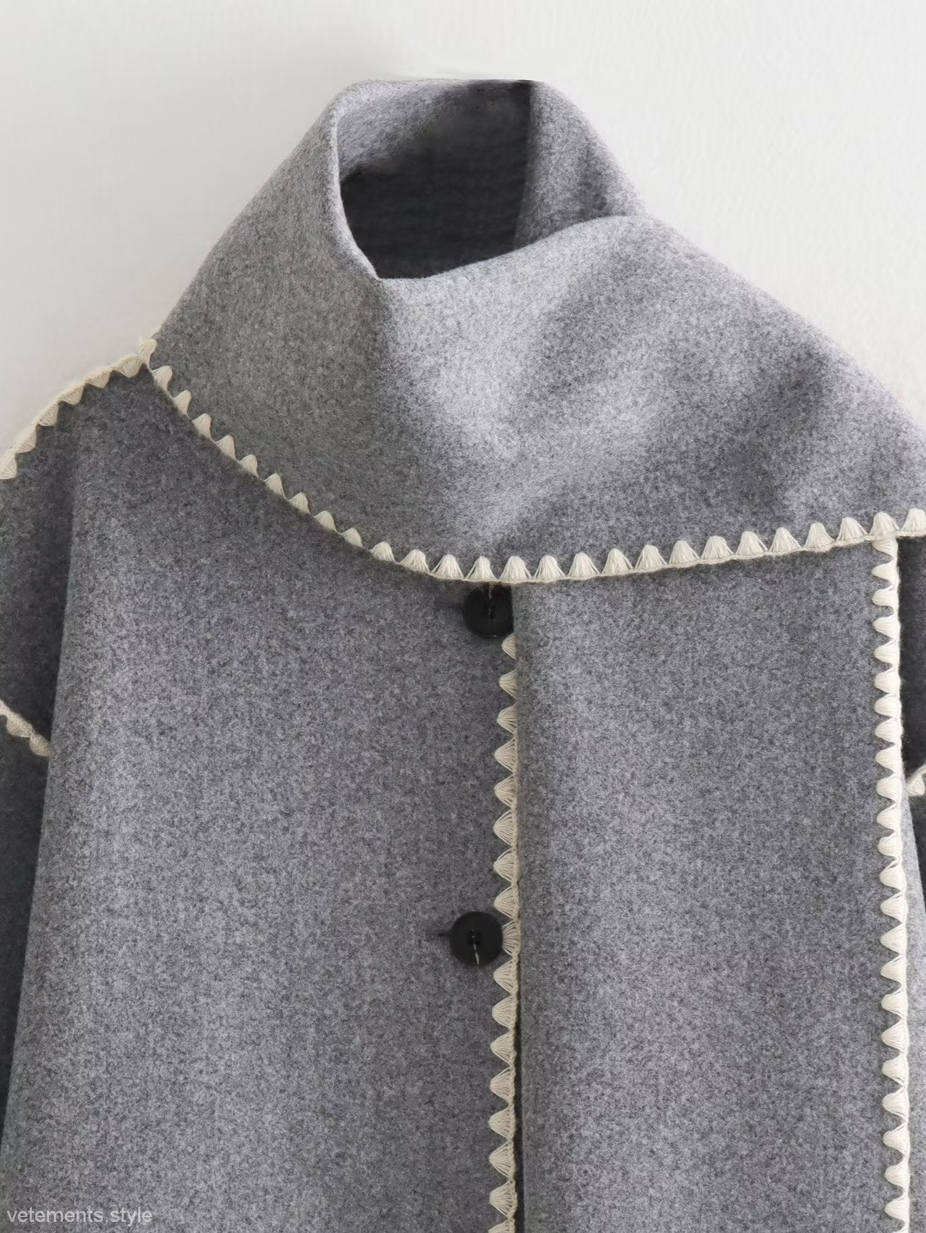 Gray wool cape with white trim showcasing the Vintage Stitching Coat in elegant design