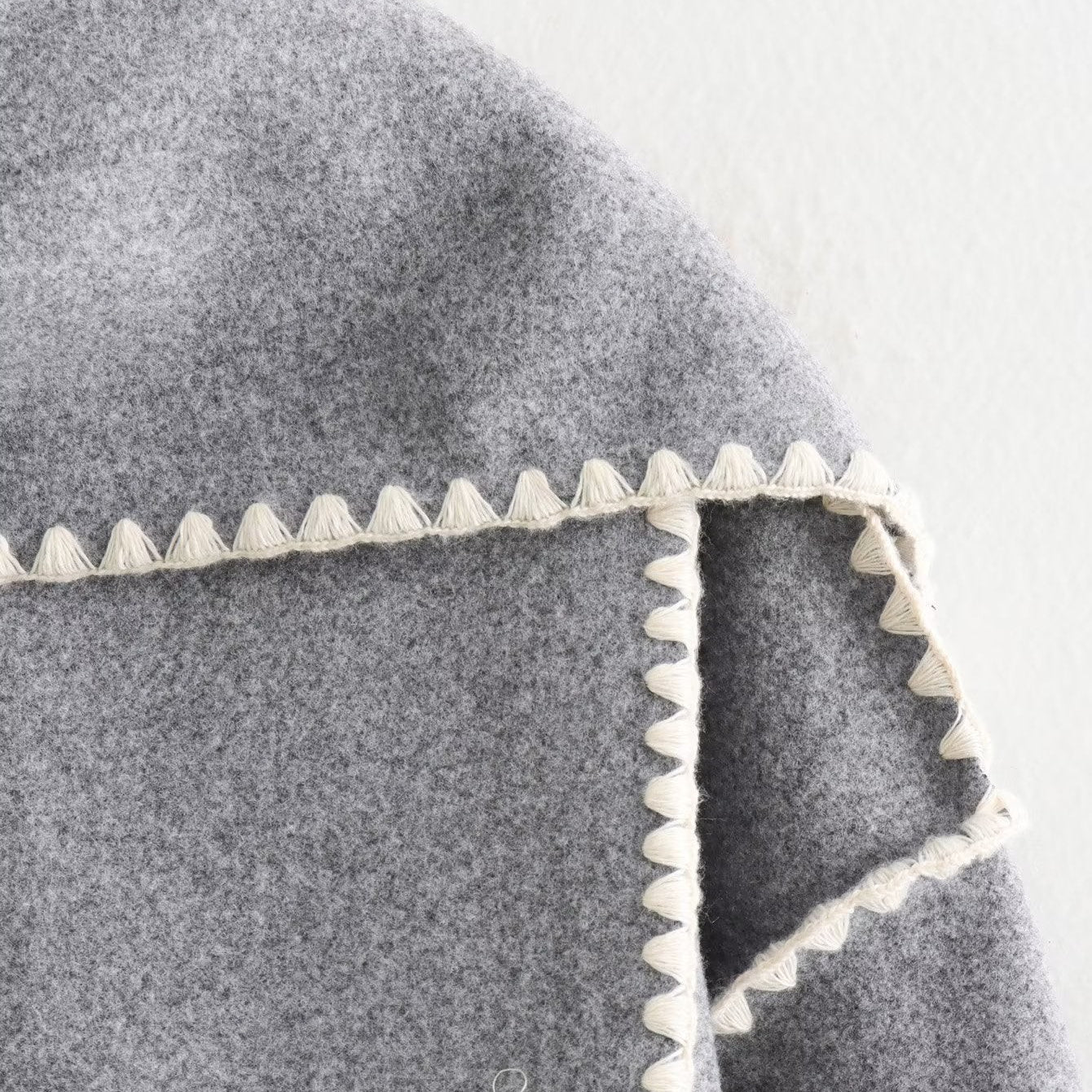 Gray wool cape with white trim from the Vintage Stitching Coat collection