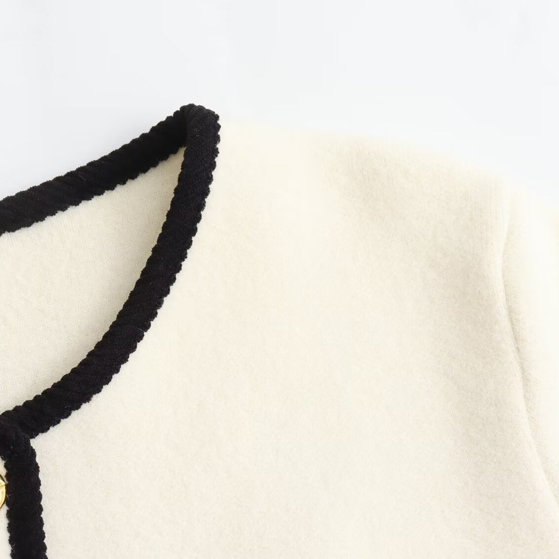 Langry fashion white Chanel jacket with black trim and gold buttons