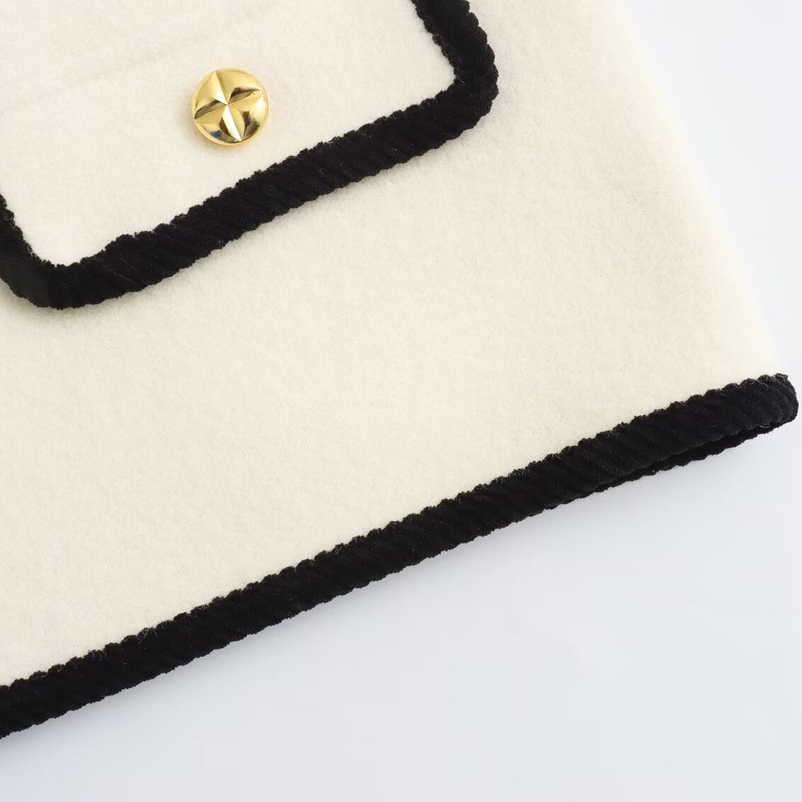 Langry fashion cream and black crocheted clutch with gold button