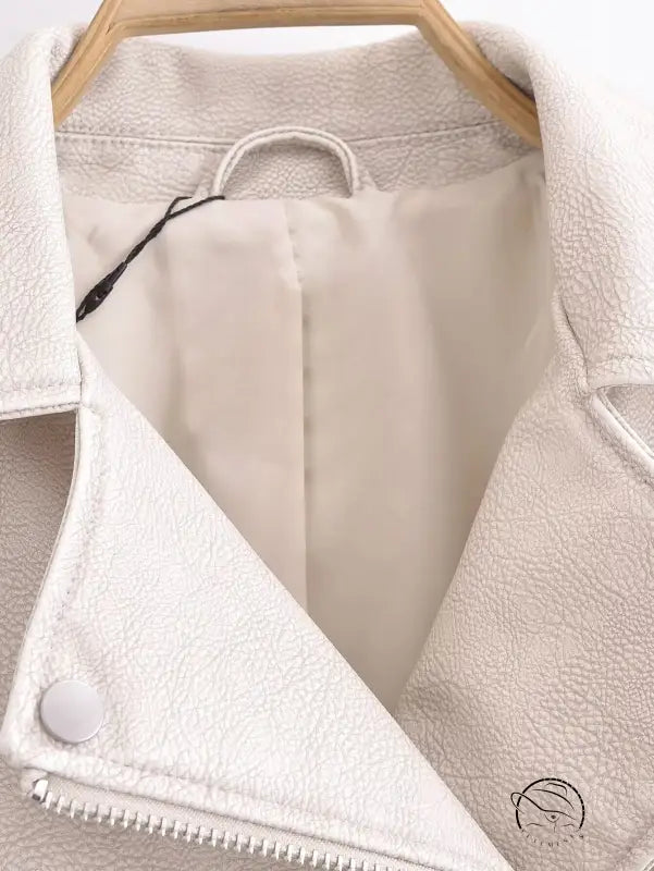 Cream-colored faux leather jacket with zipper and button closure