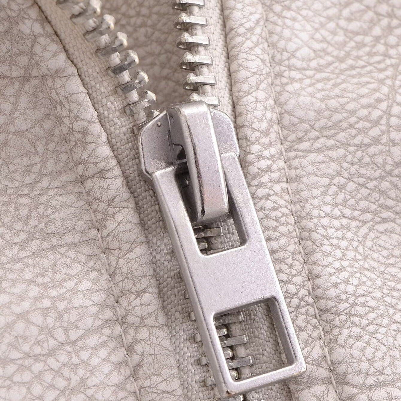 Silver zipper on retro washed faux leather jacket