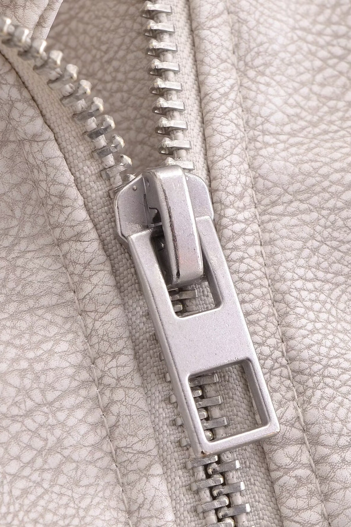Silver zipper on retro washed faux leather jacket
