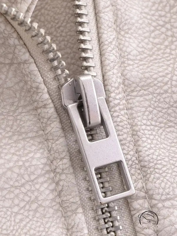 Silver zipper on retro washed faux leather jacket with textured fabric and metallic teeth