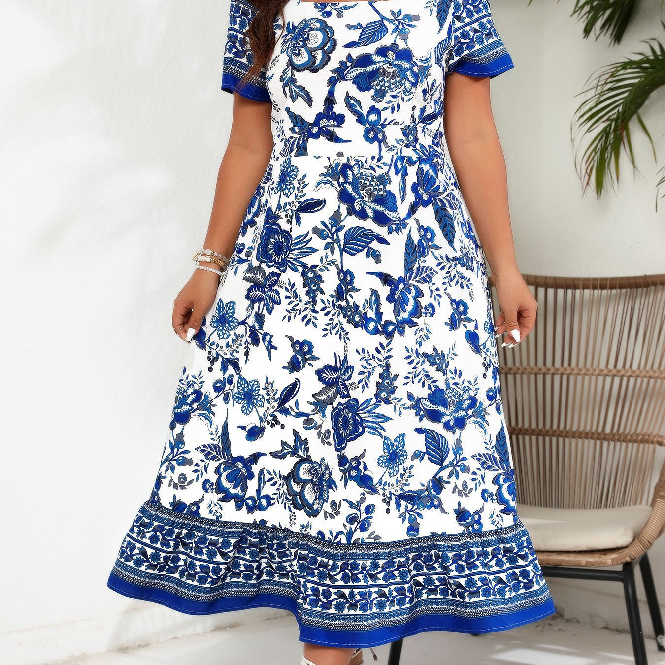 White and blue floral print maxi dress with square neckline and patterned hem detail