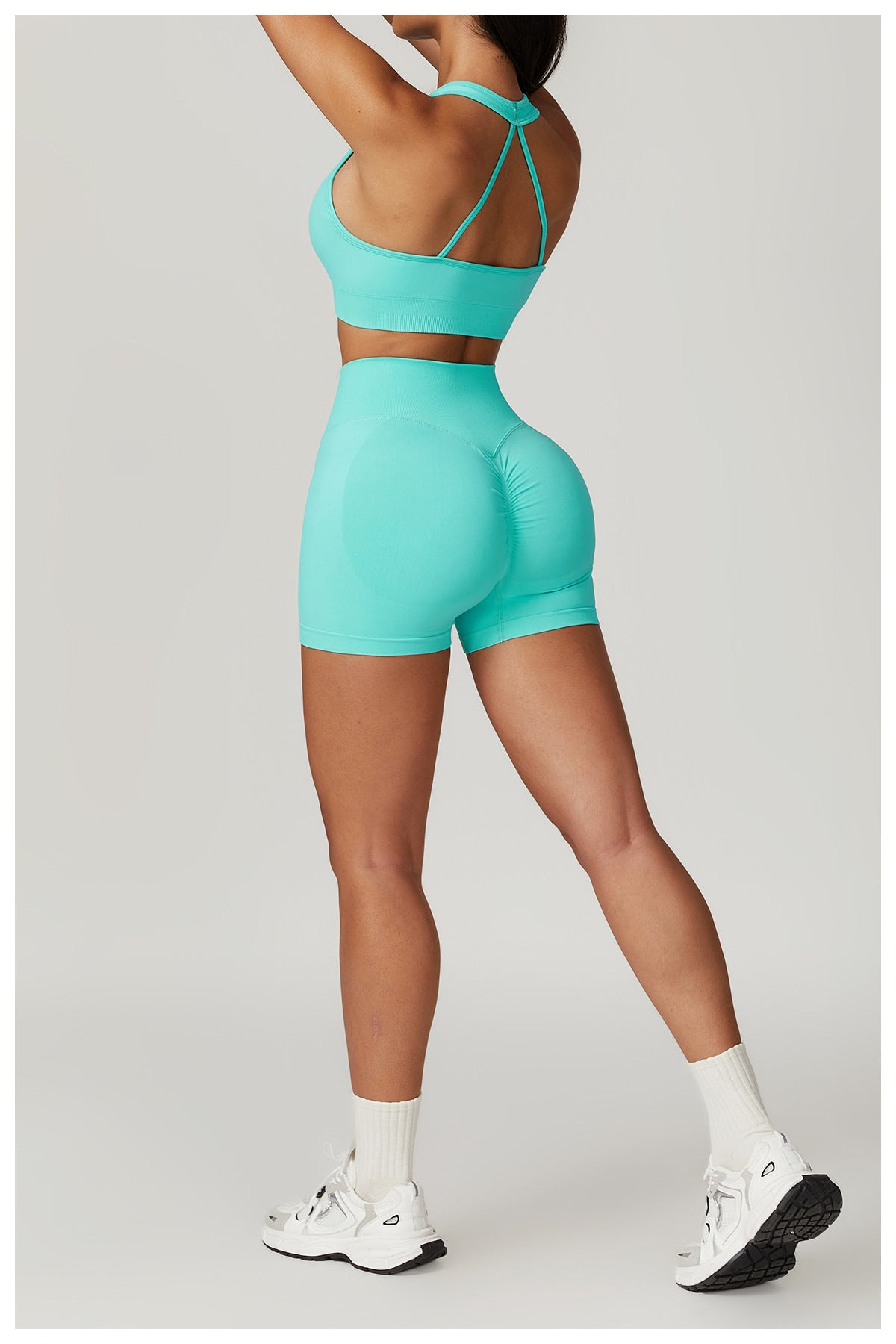 Woman in turquoise seamless yoga suit, featuring Bra Shorts Rhino design