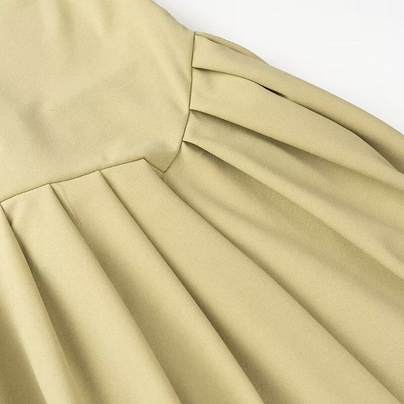 Pleated beige fabric of Spring Summer dress showcasing elegant turtleneck fashion ملابس