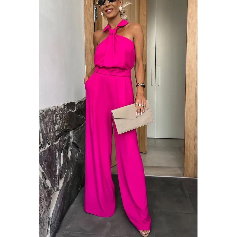 Woman in bright pink halter jumpsuit showcasing stylish summer fashion ملابس by Langry