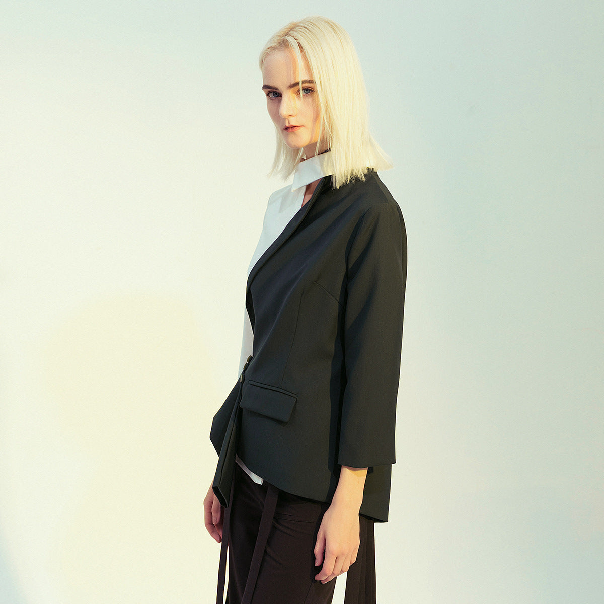 Blonde woman wearing a black and white blazer from Modern Personality fashion ملابس