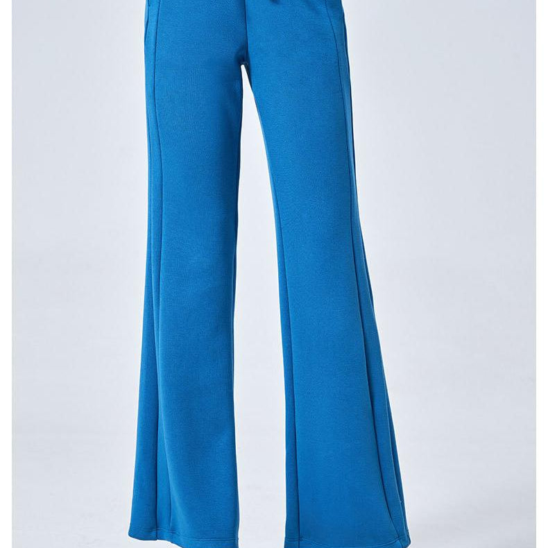 Blue drawstring wide-leg sweatpants with white sneakers, perfect for summer fashion ملابس