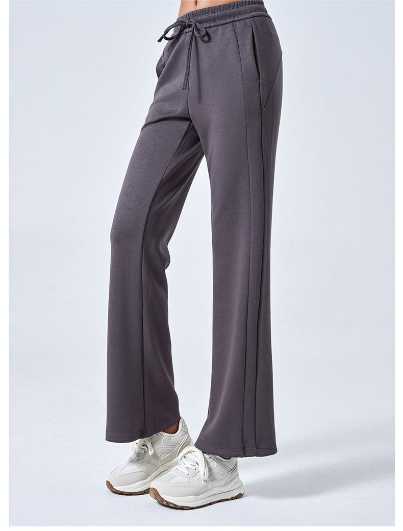 Gray flared athletic pants for women featuring drawstring waist and double pockets, ideal fashion ملابس