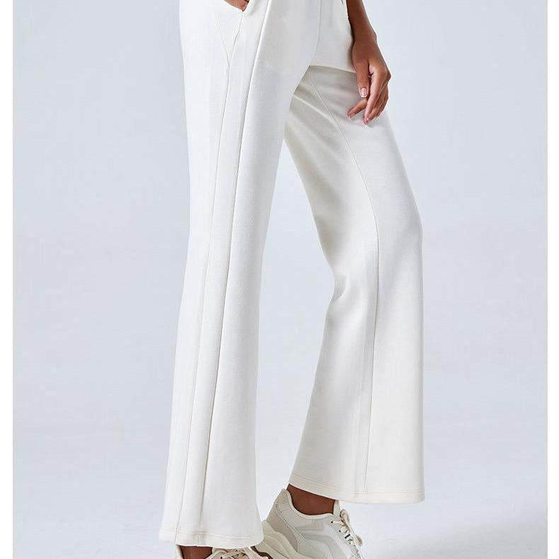 White wide-leg Summer Air Layer Pants with cream sneakers for stylish summer fashion