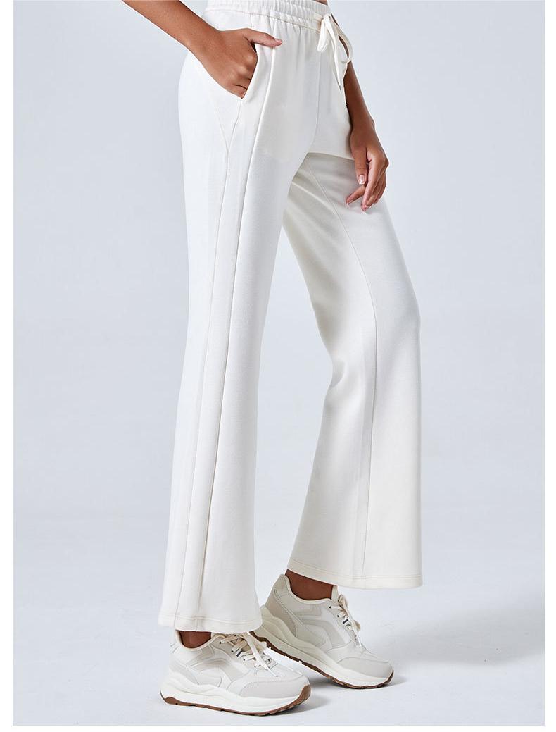 White wide-leg Summer Air Layer Pants with cream sneakers for stylish summer fashion