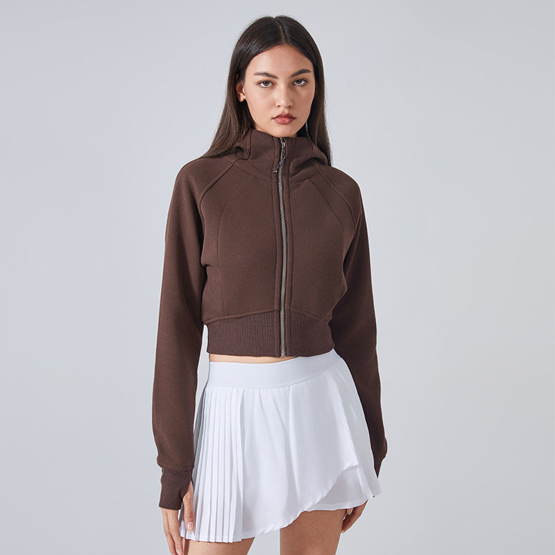 Brown cropped zip-up hoodie paired with a white skirt for stylish autumn winter fashion