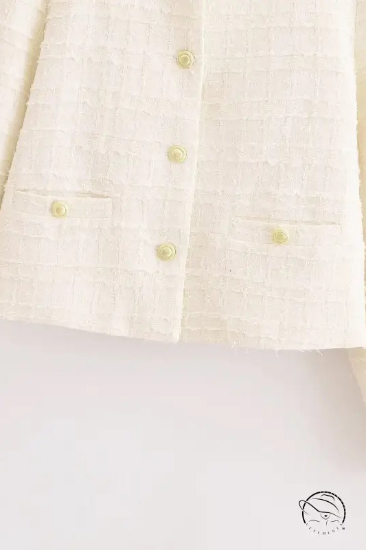 Cream-colored linen blazer with buttons, pockets, and langry fashion style