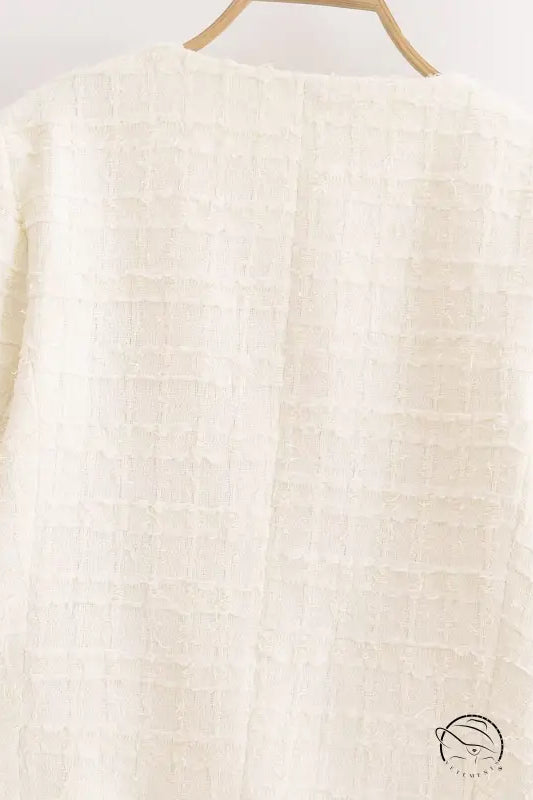 White textured grid sweater on wooden hanger, Langry winter woolen fashion coat