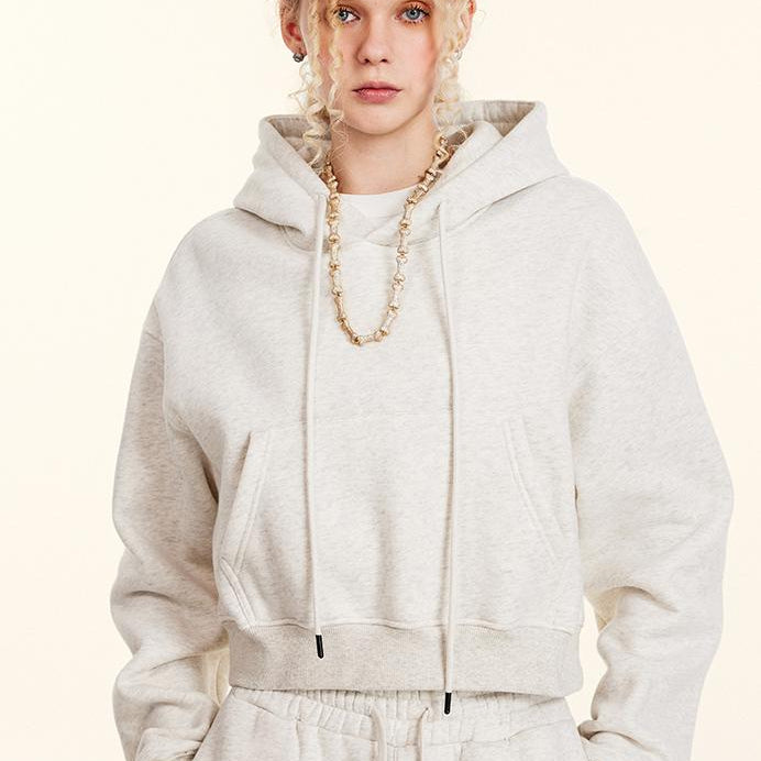 White cropped hoodie with drawstrings and gold chain necklace for stylish winter fashion