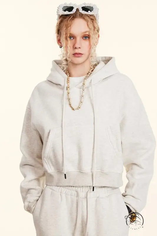 White cropped langry fashion hoodie with drawstrings and gold chain