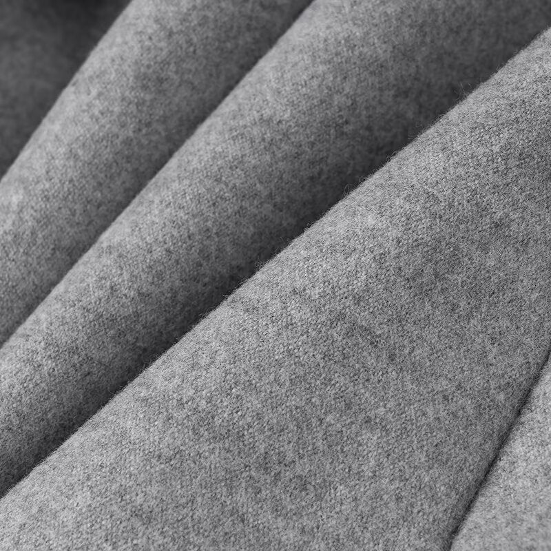 Close-up of folded heather gray fleece fabric showcasing luxurious langry fashion ملابس