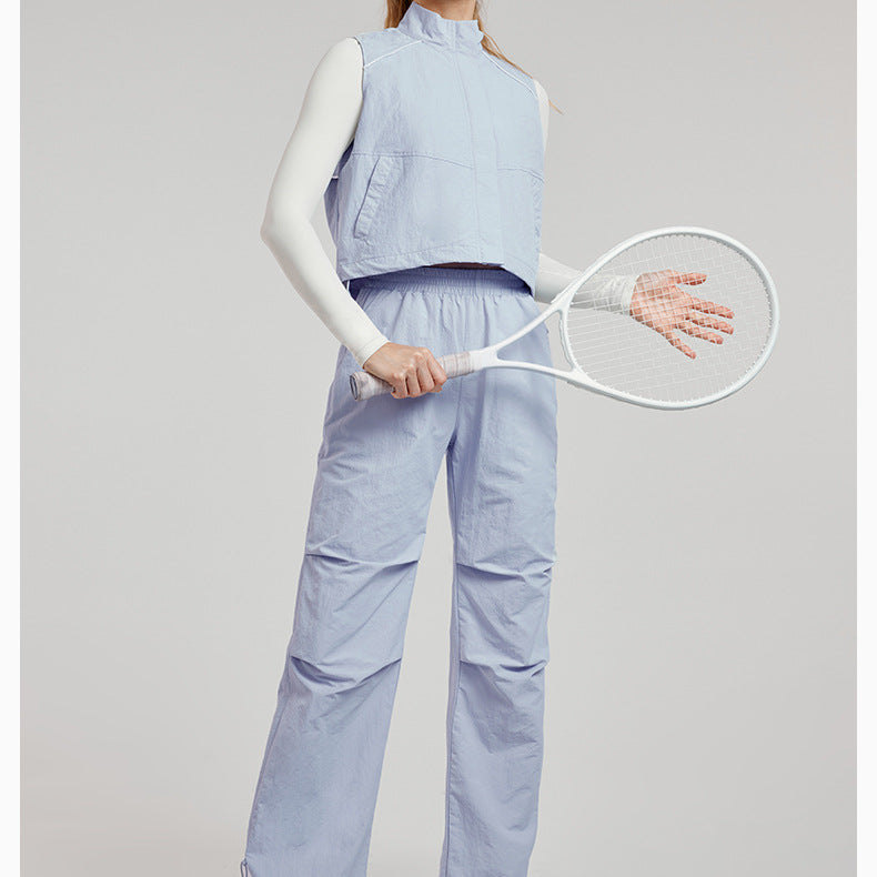 Woman in light blue athletic wear with a tennis racket showcasing stylish ملابس