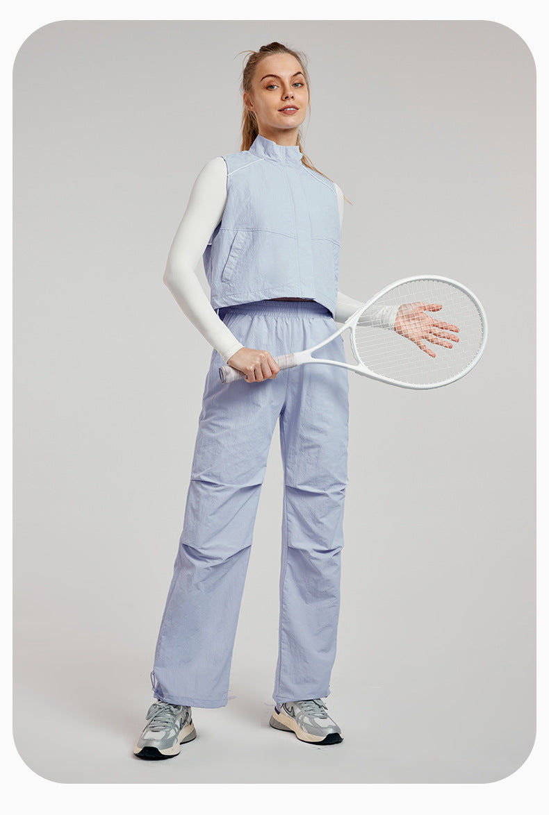 Woman in light blue athletic wear with a tennis racket showcasing stylish ملابس