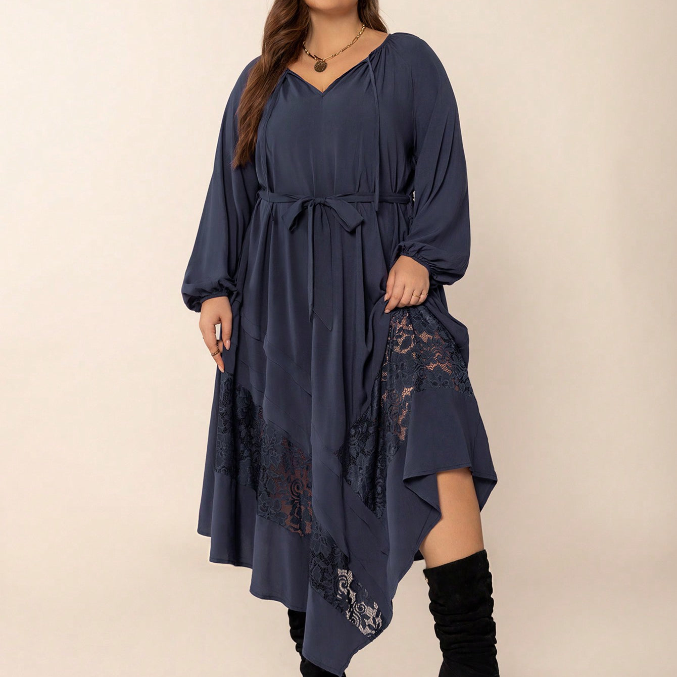 Navy blue winter cozy dress with V-neck, waist tie, lace inserts, and asymmetrical hem