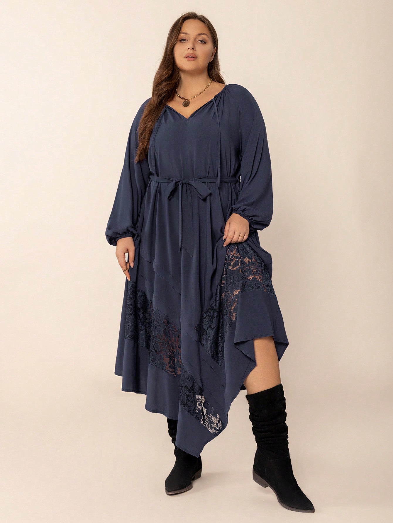 Navy blue winter cozy dress with V-neck, waist tie, lace inserts, and asymmetrical hem