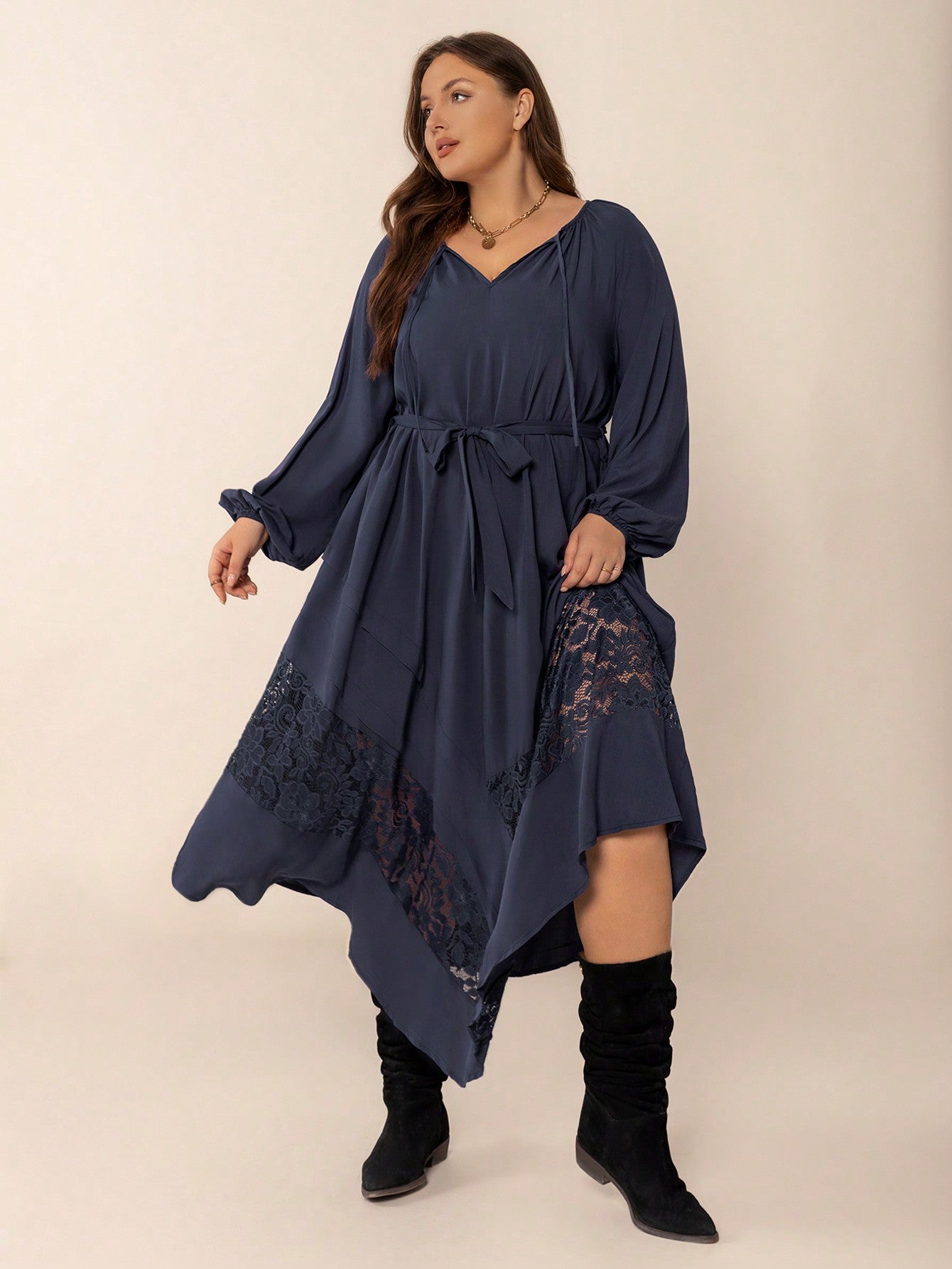Plus-size navy blue winter cozy dress with balloon sleeves and lace hem detail