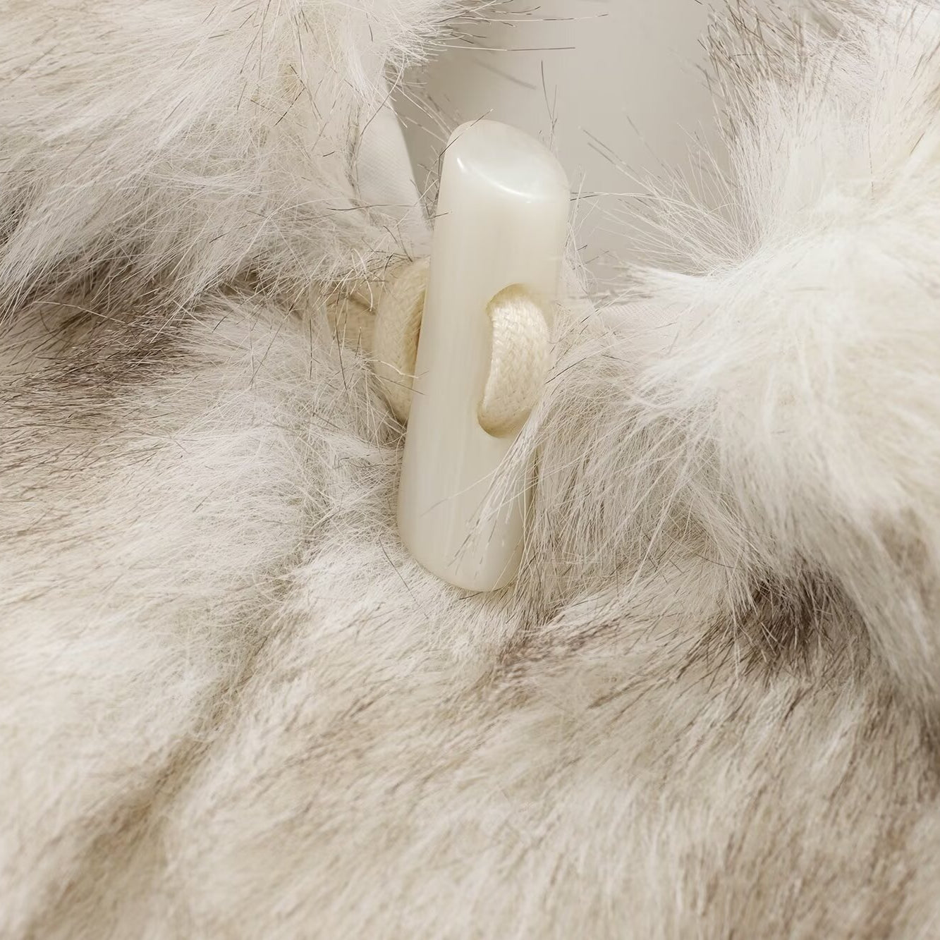 Fuzzy white and gray fur coat with toggle closure showcasing stylish fashion and ملابس