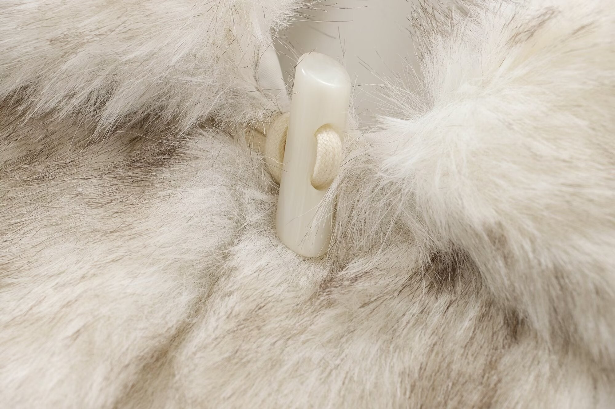 Fuzzy white and gray fur coat with toggle closure showcasing stylish fashion and ملابس