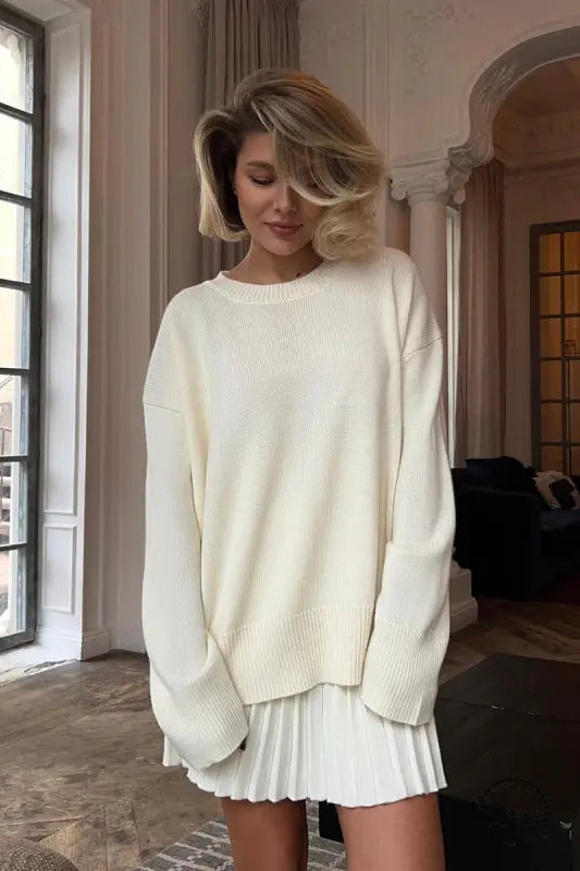 Woman in cute knitted skirt set with oversized white sweater