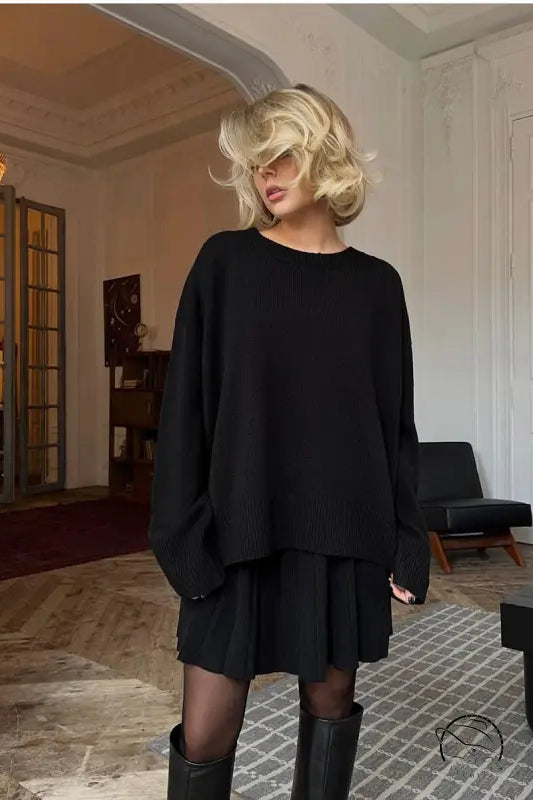 Woman in black oversized sweater and cute knitted skirt set