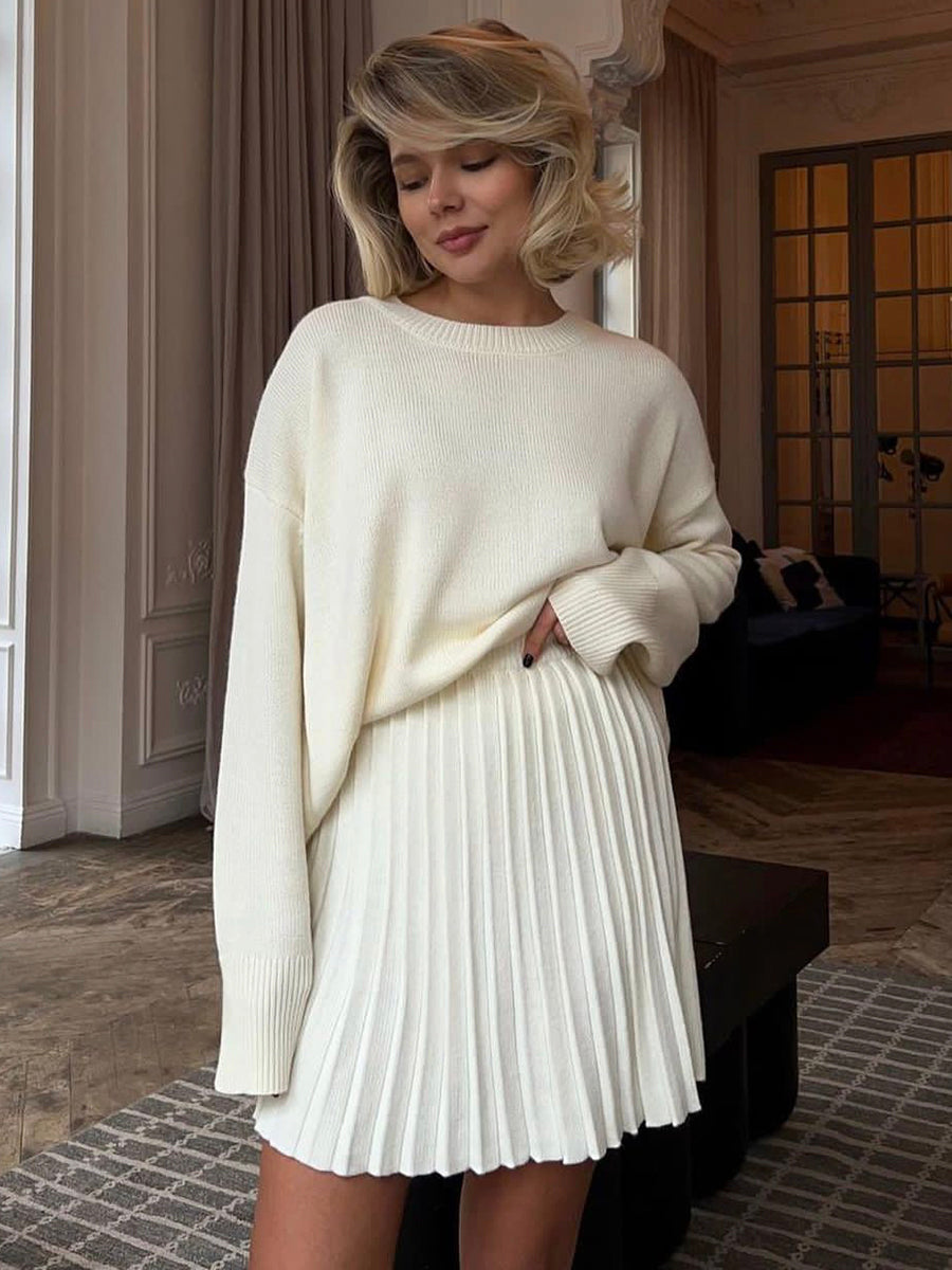 Woman in a white sweater and pleated knitted skirt from Cute Knitted Skirt Sets