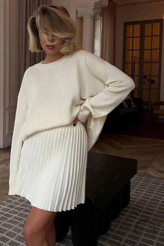 Woman in white sweater and cute knitted skirt set