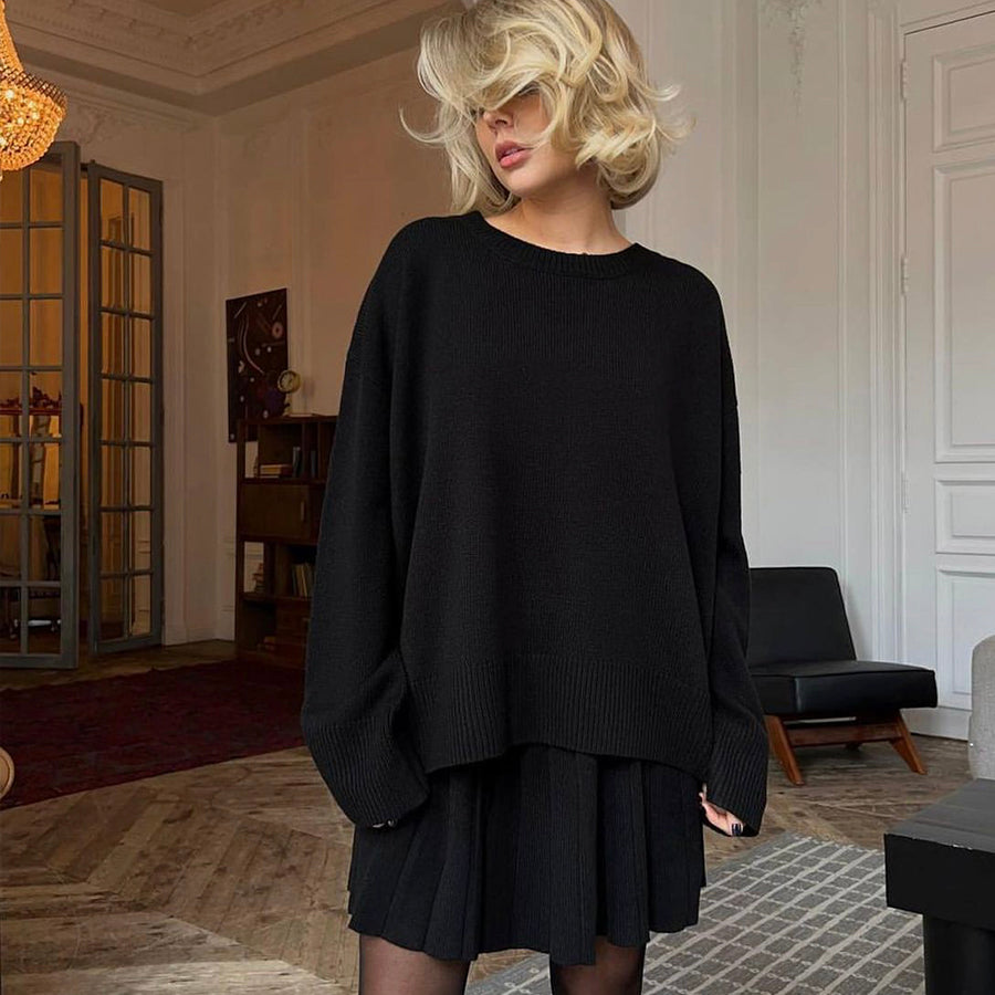 Woman in black oversized sweater and boots showcasing a cute knitted skirt set