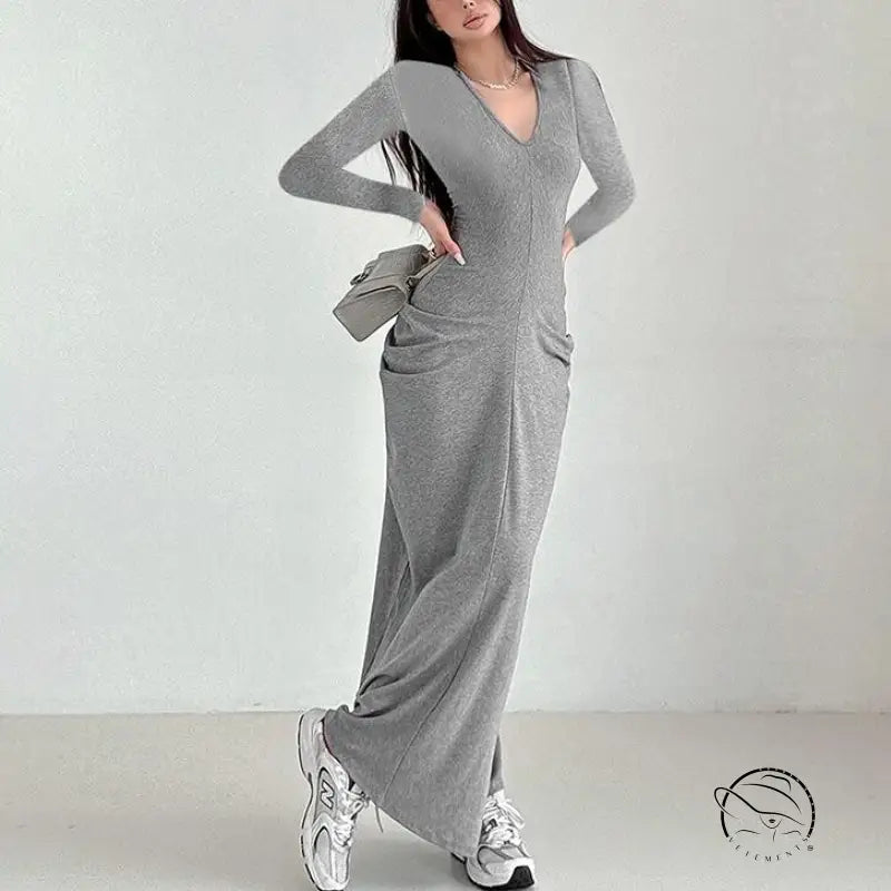 Long grey knit fashion dress with V-neck, long sleeves, and white sneakers
