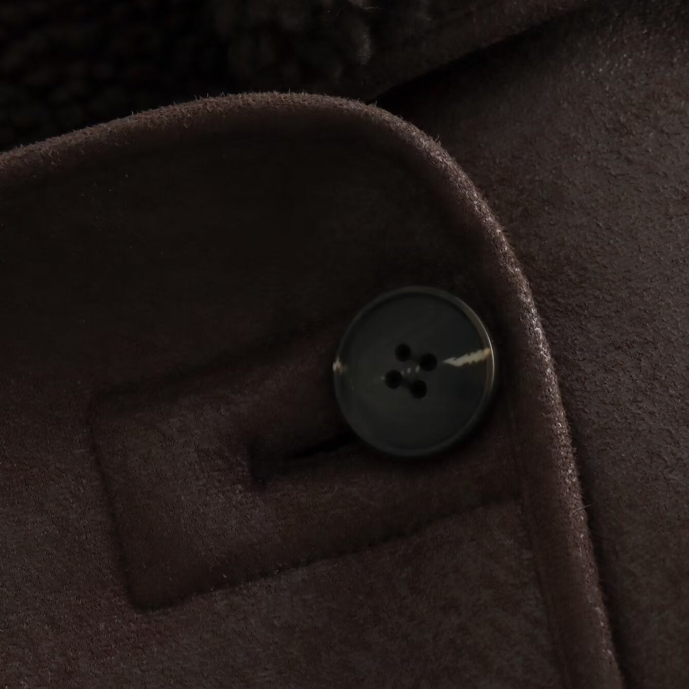 Elegant langry fashion jacket with silver button on brown fabric