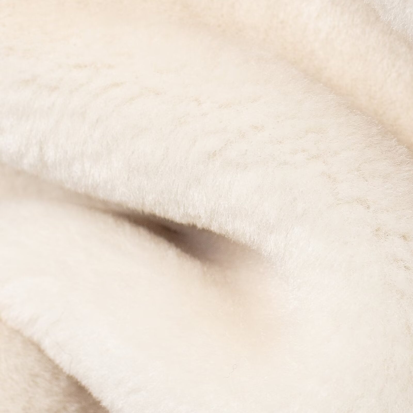 Soft white folded fabric of the Winter Double Sided String Button Jacket featuring faux fur fashion