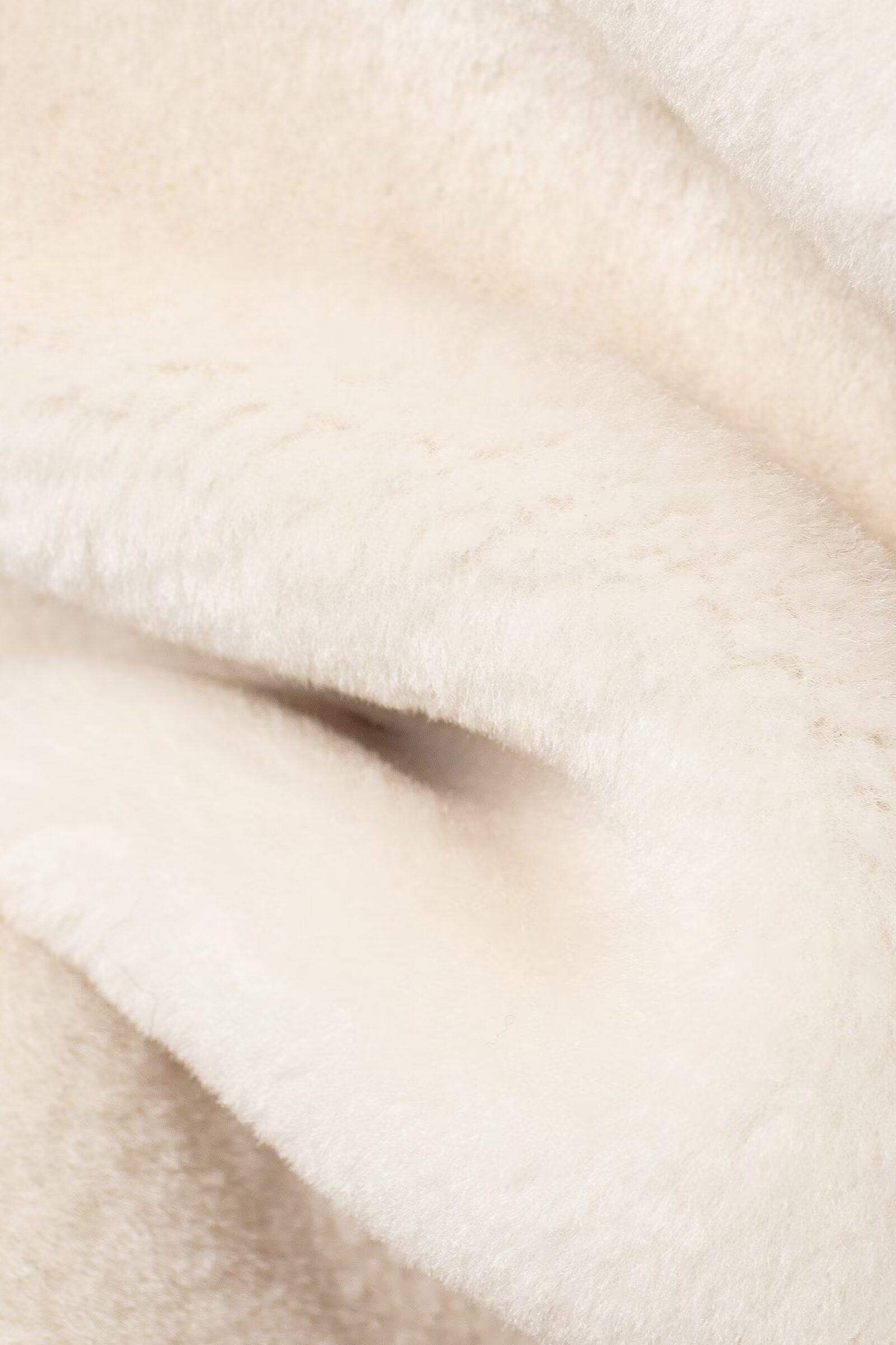 Soft white folded fabric of the Winter Double Sided String Button Jacket featuring faux fur fashion