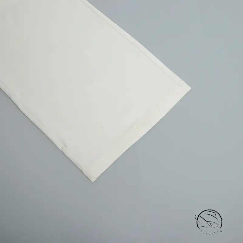 Folded pure white bedsheet for office matching trousers