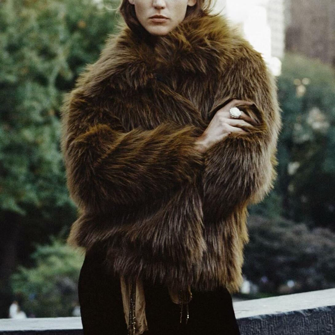 Faux fur short jacket with shaggy brown texture and large cream-colored ring for fashion