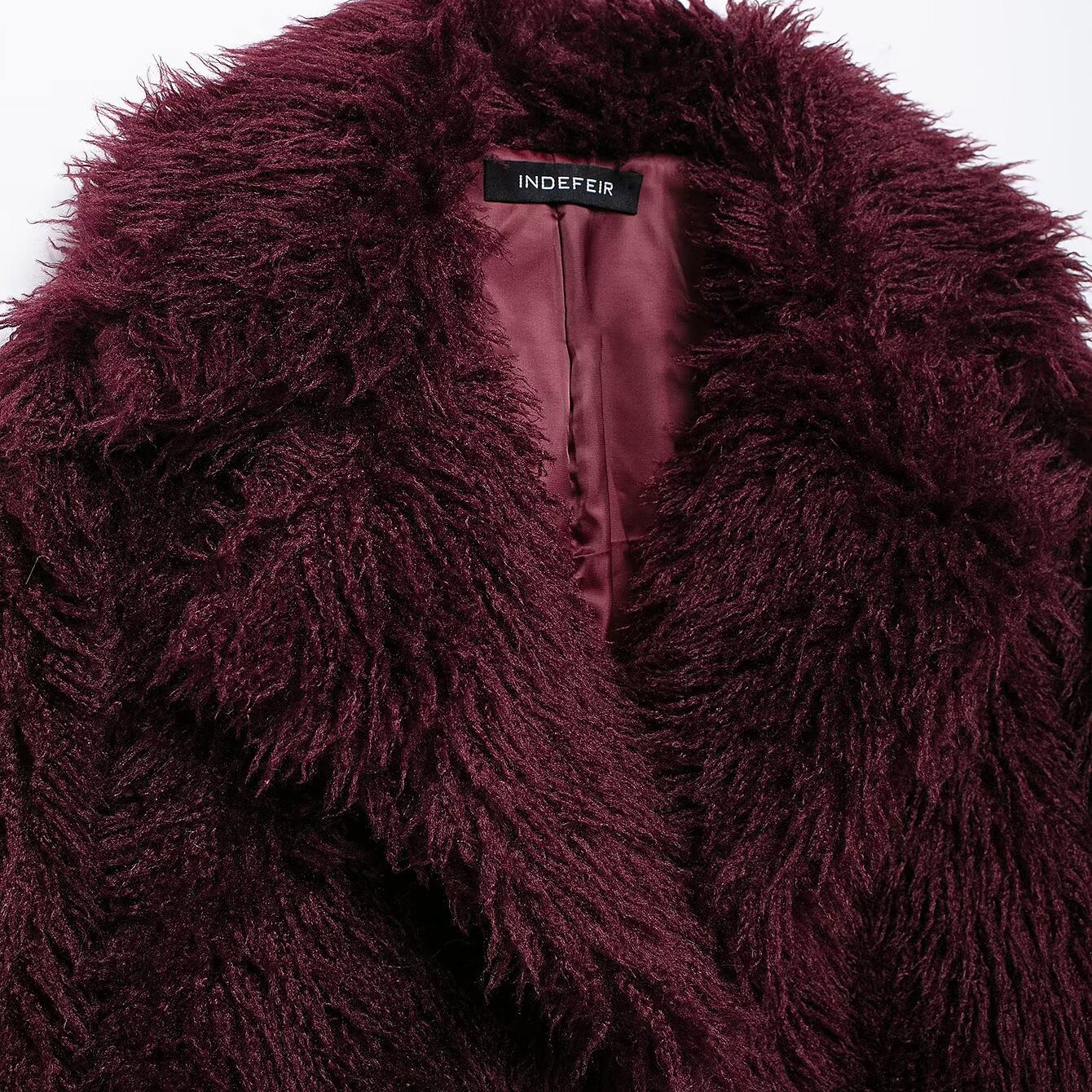 Dark red shaggy faux fur coat showcasing luxurious faux fur fashion style