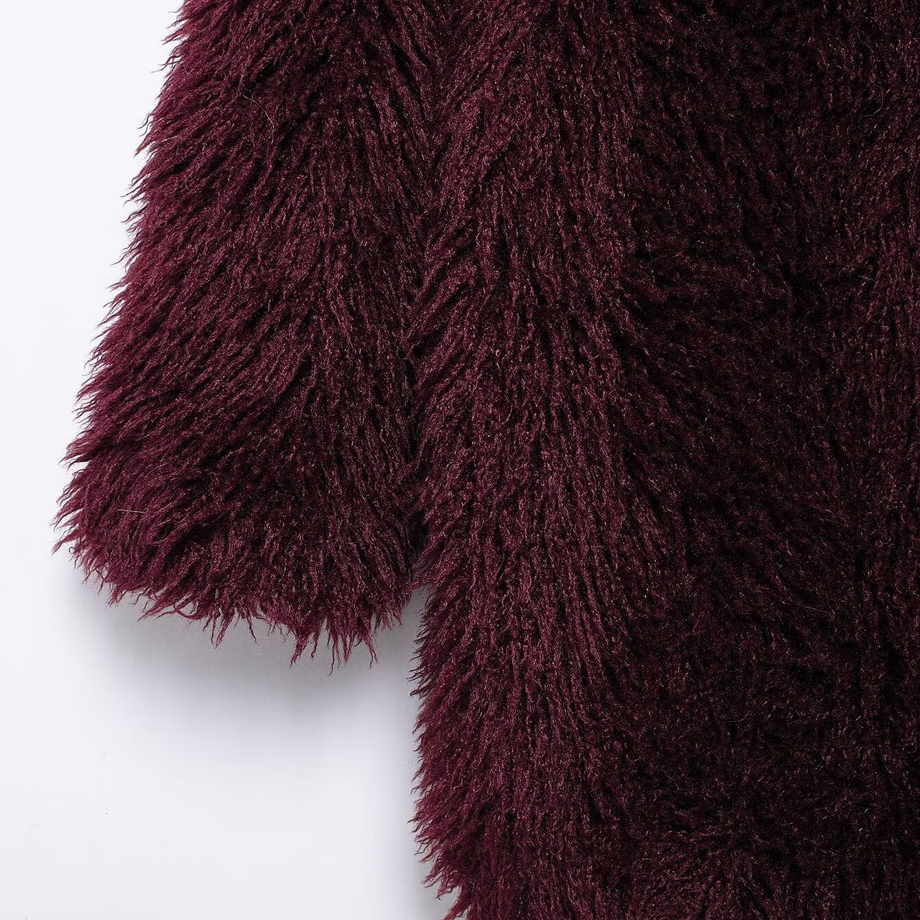 Close-up of dark red faux fur effect mid-length coat with long sleeves for fashion