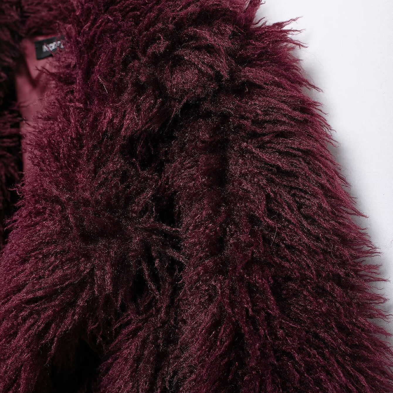 Burgundy faux fur coat showcasing luxurious faux fur fashion and elegant style
